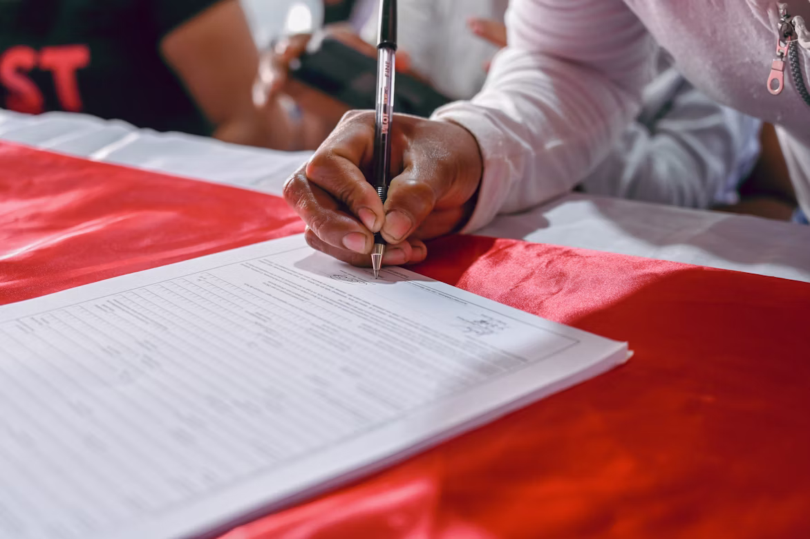 A person filling in a form